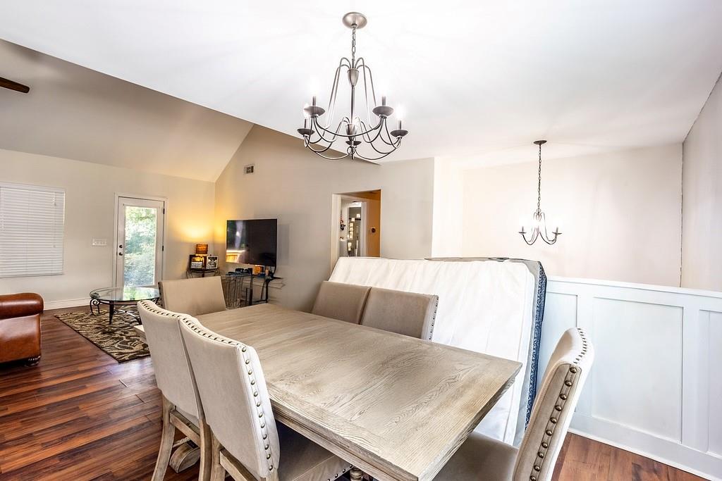 3907 Robin Court Acworth, GA 30101 - Photo 6 of 29 a living room with furniture a chandelier and a dining table