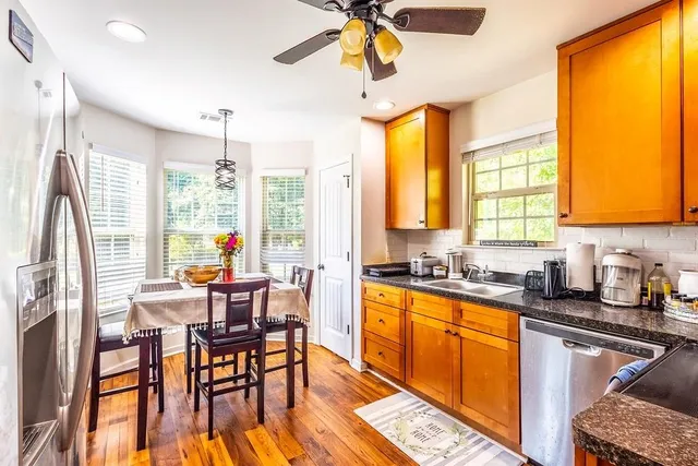 a kitchen with stainless steel appliances granite countertop sink stove top oven and cabinets