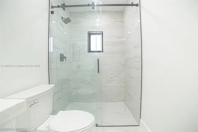 a view of an empty room and a window