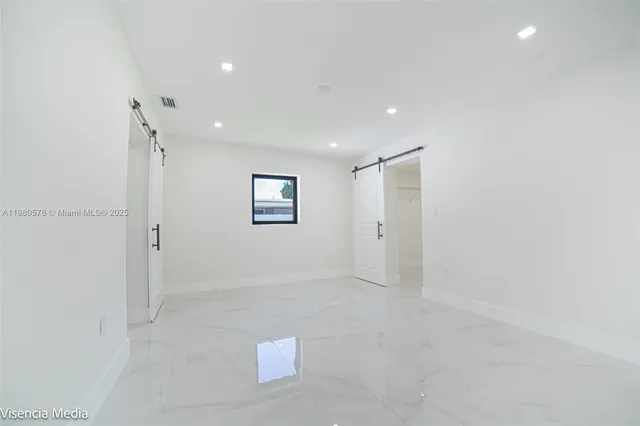 a bathroom with a glass shower door