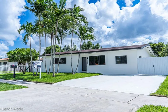 a house with palm tree in front of it