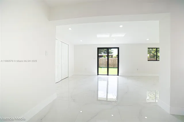 a backyard of a house with lots of green space and plants