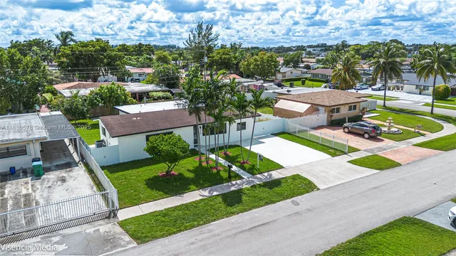 an aerial view of residential houses with outdoor space and lake view