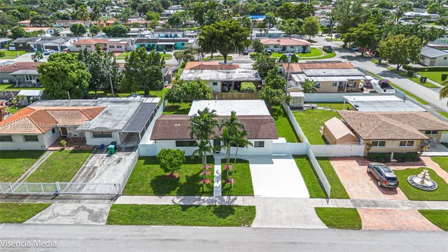 a front view of a house with a garden and plants
