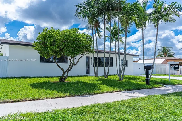 a green field with some trees in the background