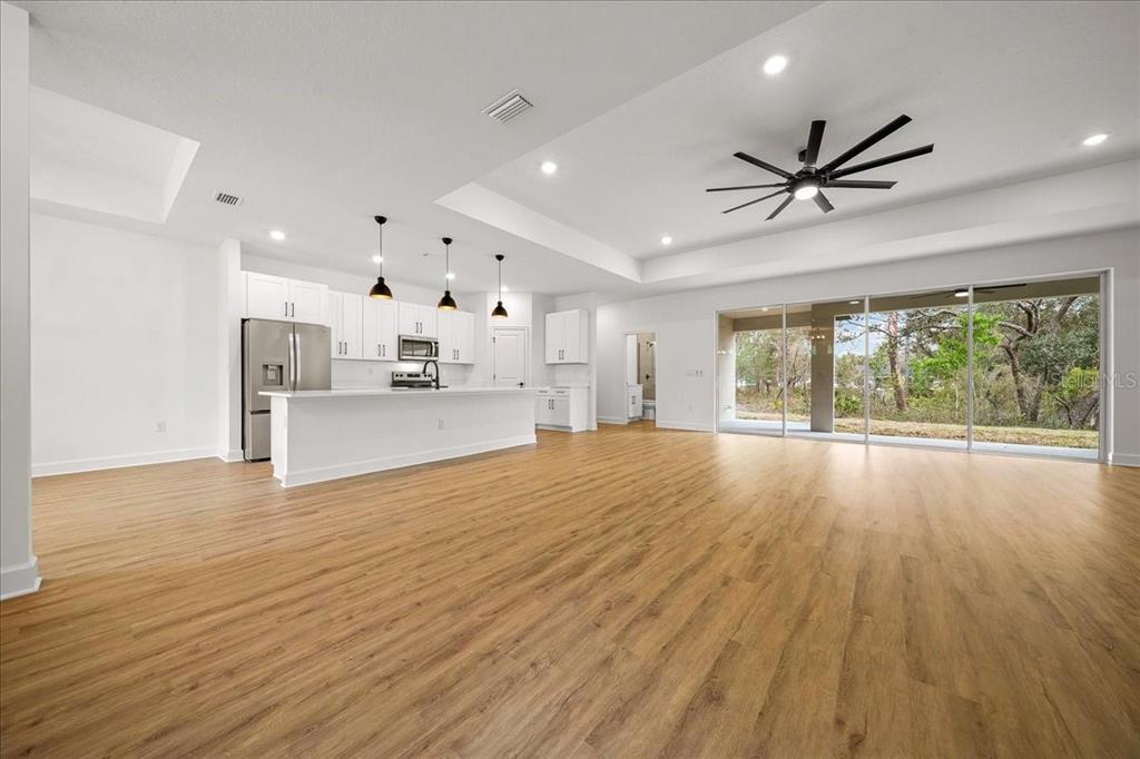11088 Fulton Avenue Weeki Wachee, FL 34613 - Photo 15 of 63 a view of empty room with wooden floor and window