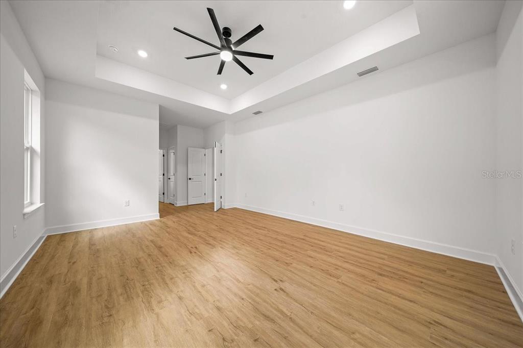 11088 Fulton Avenue Weeki Wachee, FL 34613 - Photo 24 of 63 an empty room with wooden floor and windows