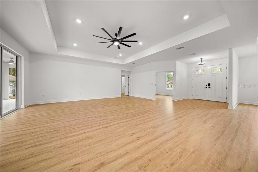 11088 Fulton Avenue Weeki Wachee, FL 34613 - Photo 25 of 63 a view of empty room with wooden floor and fan