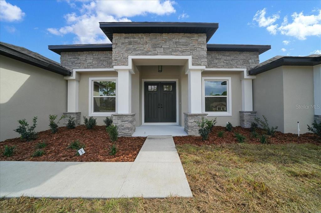 11088 Fulton Avenue Weeki Wachee, FL 34613 - Photo 3 of 63 a front view of a house with garden