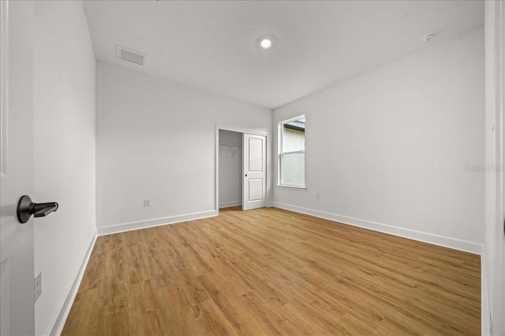 11088 Fulton Avenue Weeki Wachee, FL 34613 - Photo 33 of 63 a view of empty room with wooden floor and fan