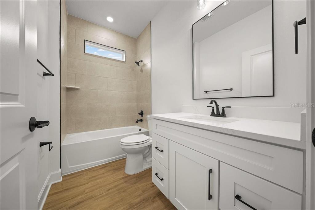 11088 Fulton Avenue Weeki Wachee, FL 34613 - Photo 35 of 63 a bathroom with a sink a toilet and shower