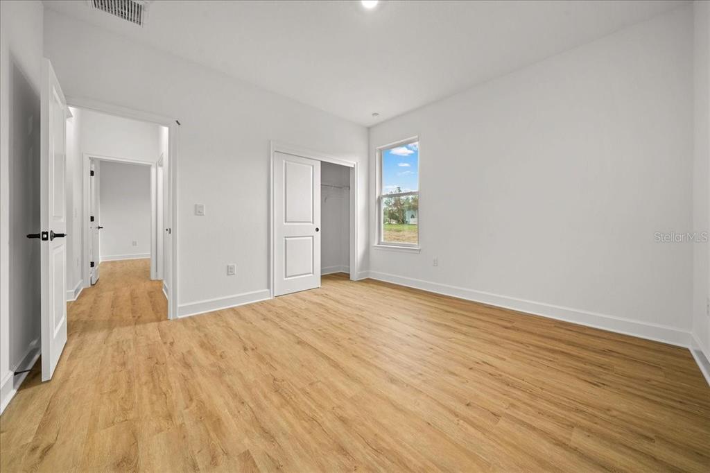 11088 Fulton Avenue Weeki Wachee, FL 34613 - Photo 38 of 63 a view of empty room with wooden floor