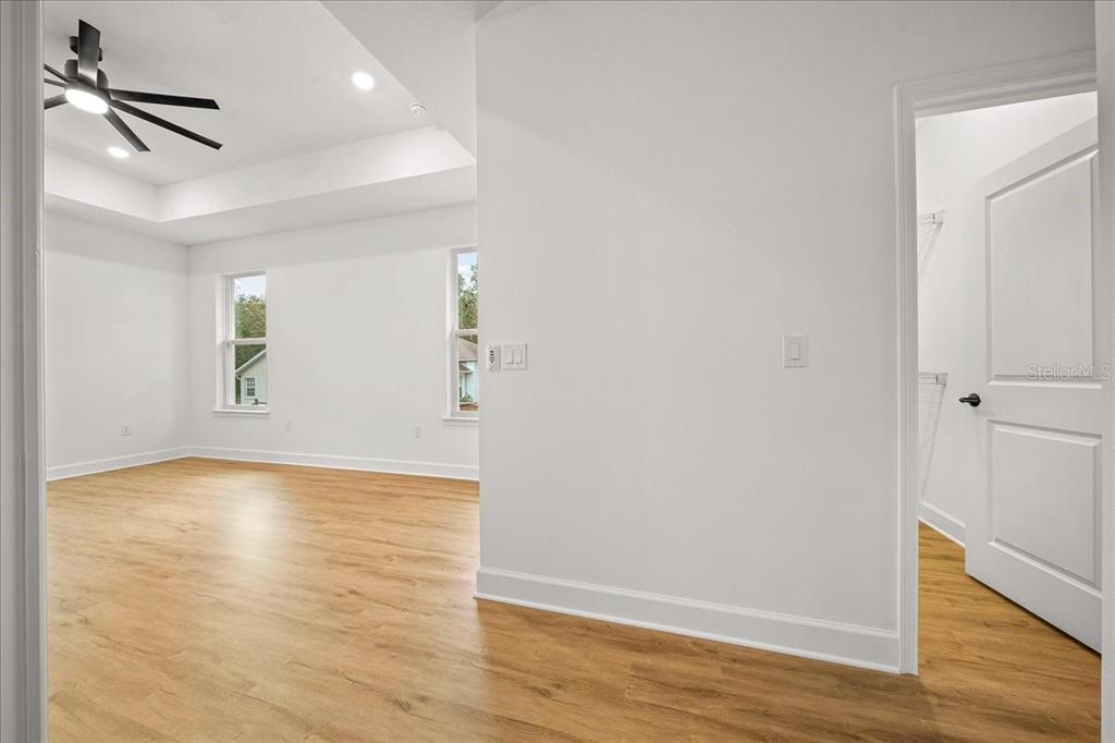 11088 Fulton Avenue Weeki Wachee, FL 34613 - Photo 40 of 63 a view of an empty room with wooden floor and a window