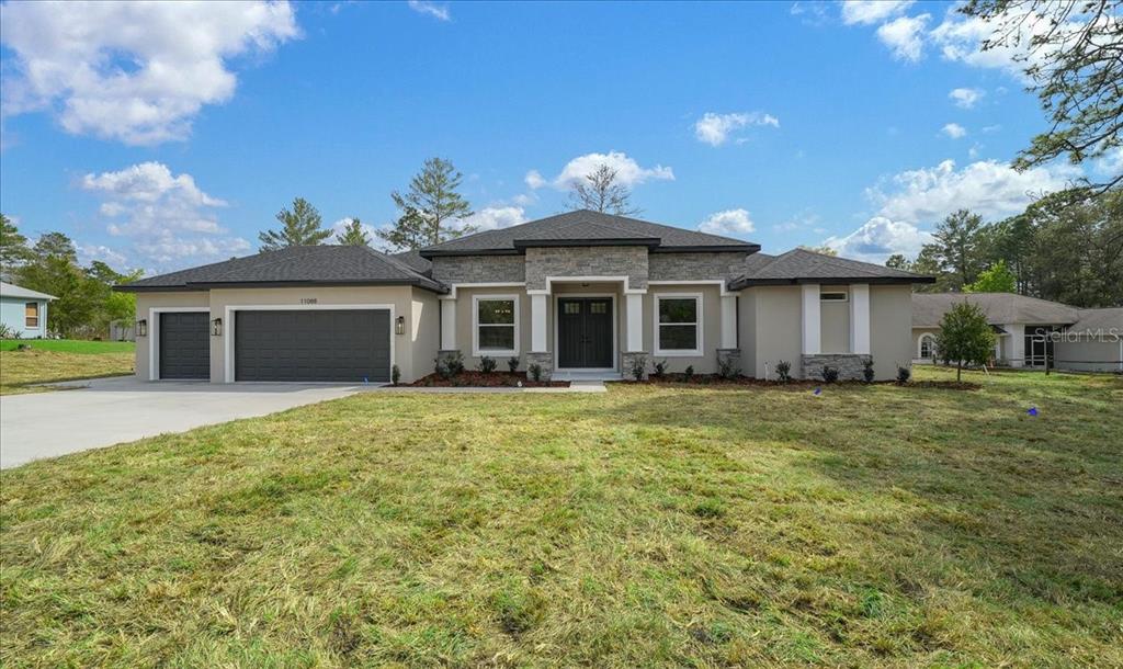 11088 Fulton Avenue Weeki Wachee, FL 34613 - Photo 61 of 63 a front view of a house with a garden