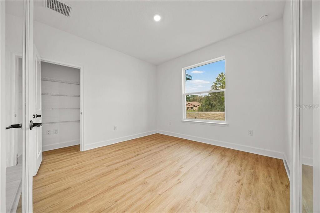 11088 Fulton Avenue Weeki Wachee, FL 34613 - Photo 8 of 63 wooden floor in an empty room with a window