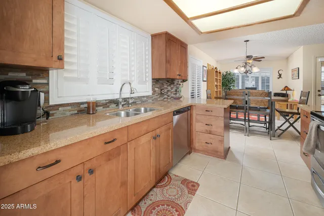 a kitchen with cabinets and chairs