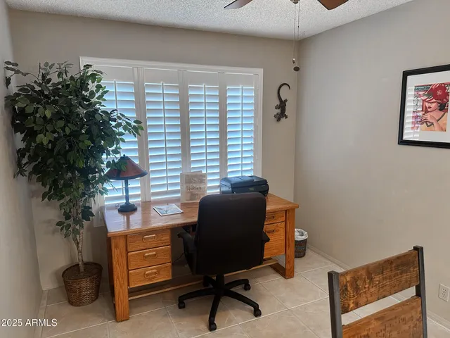 a view of a workspace with furniture and a potted plant