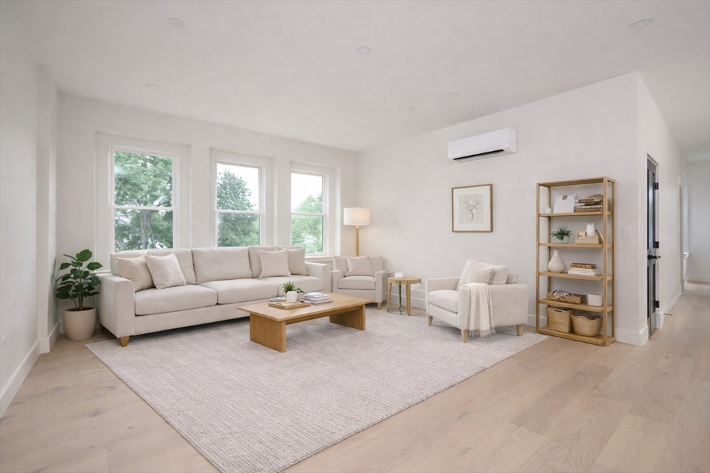 21 Tanglewood Road, Unit 3 Boston, MA 02126 - Photo 6 of 22 a living room with furniture and a large window