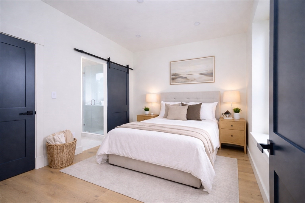 21 Tanglewood Road, Unit 3 Boston, MA 02126 - Photo 7 of 22 a bedroom with a bed and wooden floor