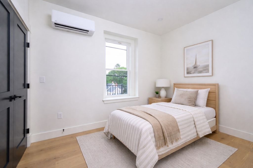 21 Tanglewood Road, Unit 3 Boston, MA 02126 - Photo 10 of 22 a bedroom with a bed and a window