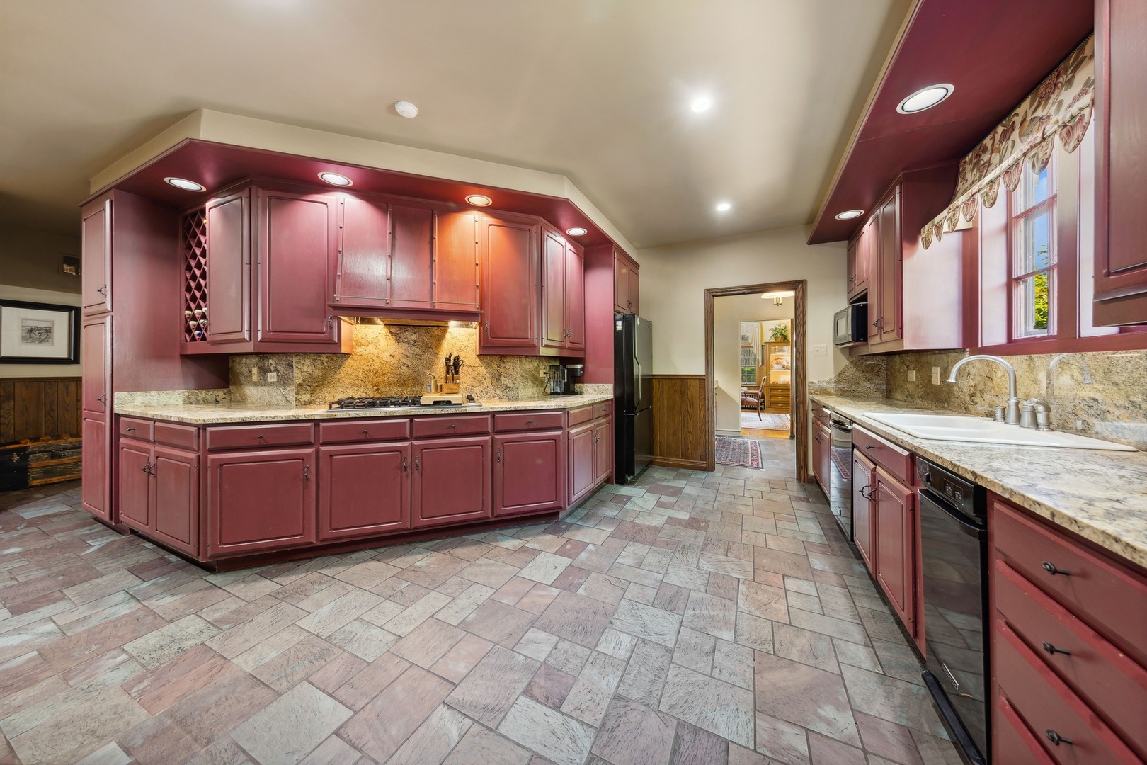 719 South County Line Road Hinsdale, IL 60521 - Photo 15 of 52 a large kitchen with kitchen island granite countertop a stove and cabinets