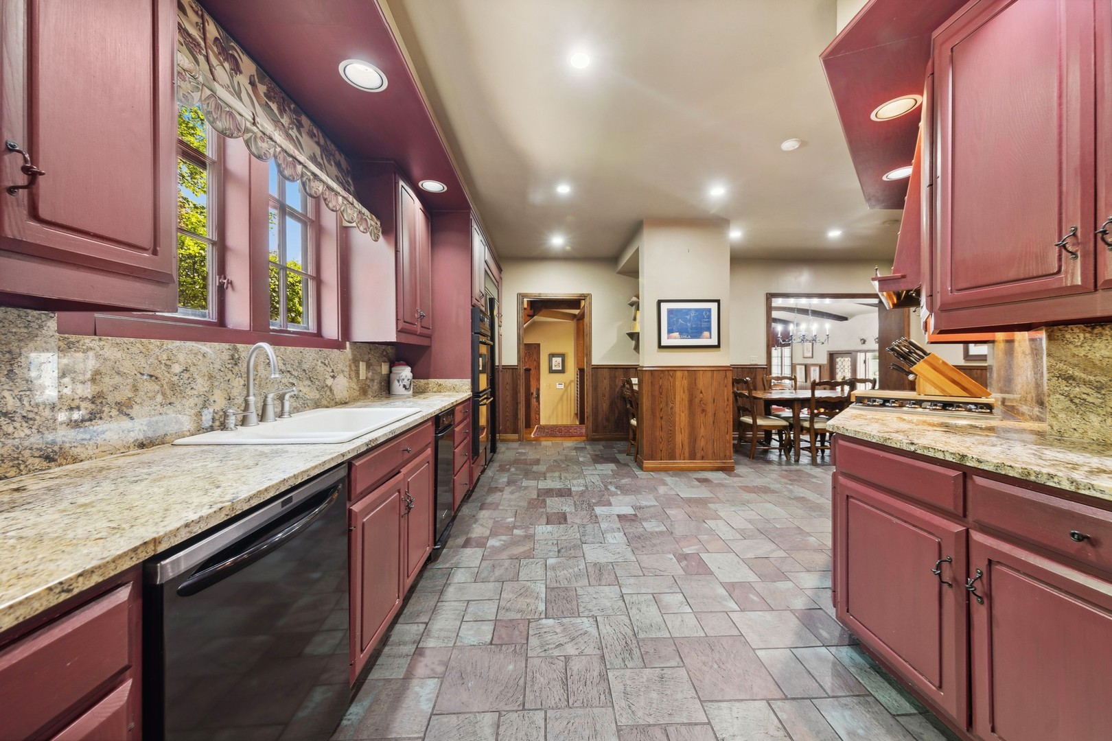 719 South County Line Road Hinsdale, IL 60521 - Photo 16 of 52 a large kitchen with stainless steel appliances granite countertop a large counter top and stove