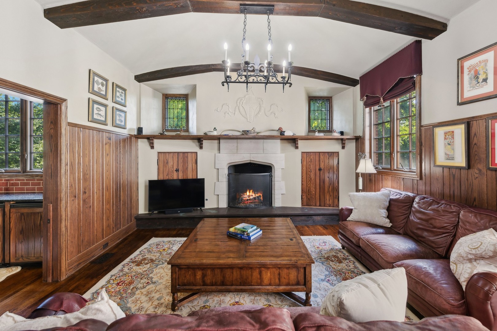 719 South County Line Road Hinsdale, IL 60521 - Photo 20 of 52 a living room with furniture a fireplace and a chandelier