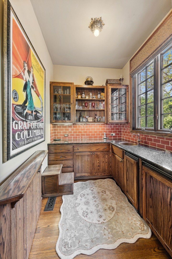 719 South County Line Road Hinsdale, IL 60521 - Photo 21 of 52 a kitchen with a stove a sink and a refrigerator