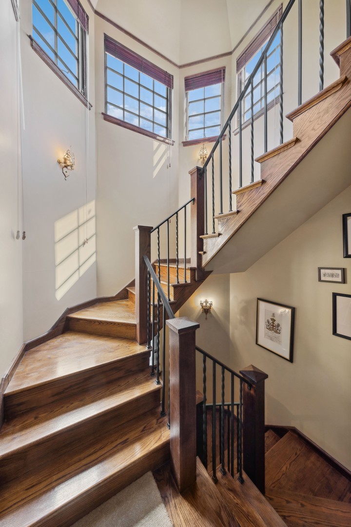 719 South County Line Road Hinsdale, IL 60521 - Photo 27 of 52 a view of staircase with lots of frames on wall and a window