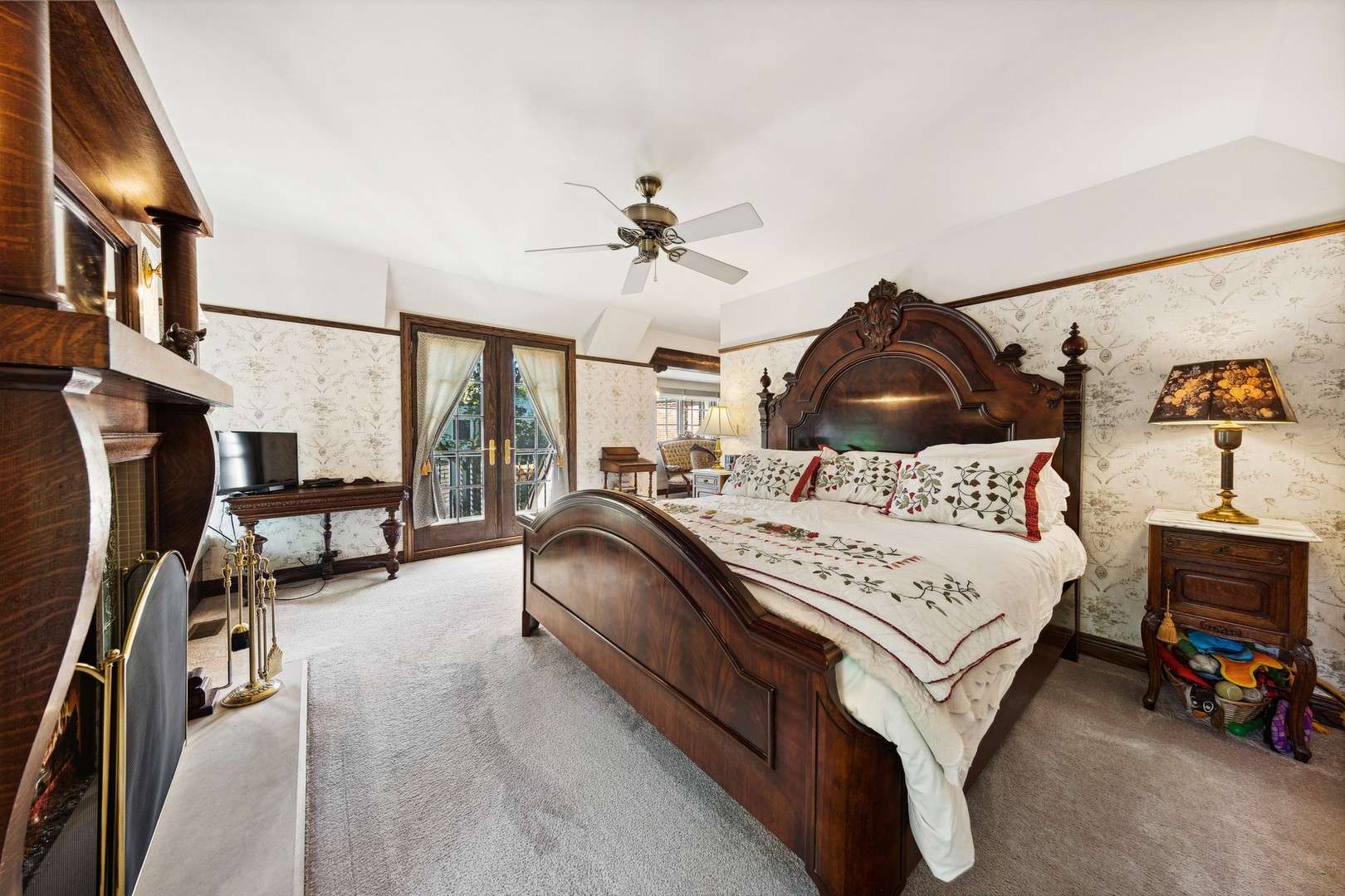 719 South County Line Road Hinsdale, IL 60521 - Photo 30 of 52 a bedroom with a bed a couch and a chandelier