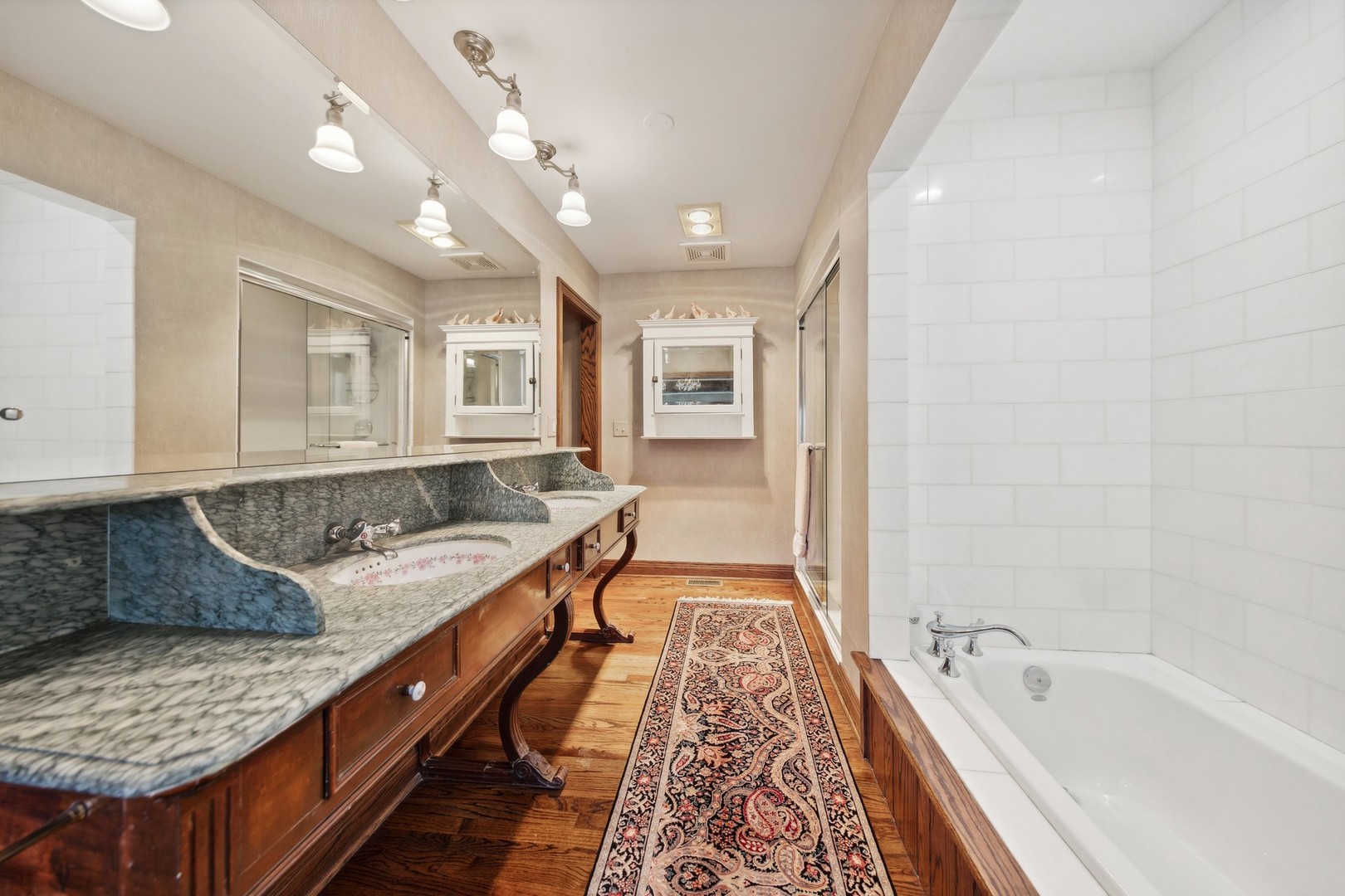 719 South County Line Road Hinsdale, IL 60521 - Photo 32 of 52 a spacious bathroom with a granite countertop tub double vanity and a sink