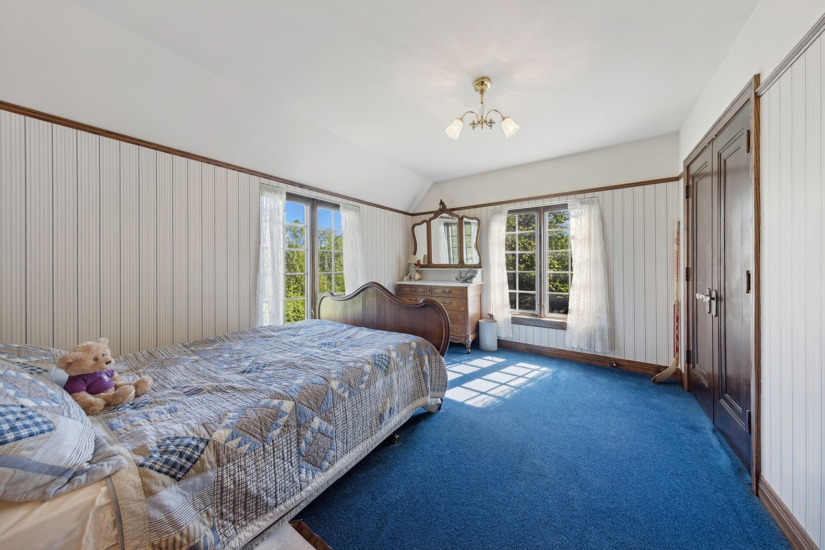 719 South County Line Road Hinsdale, IL 60521 - Photo 36 of 52 a bedroom with a large bed and a chandelier