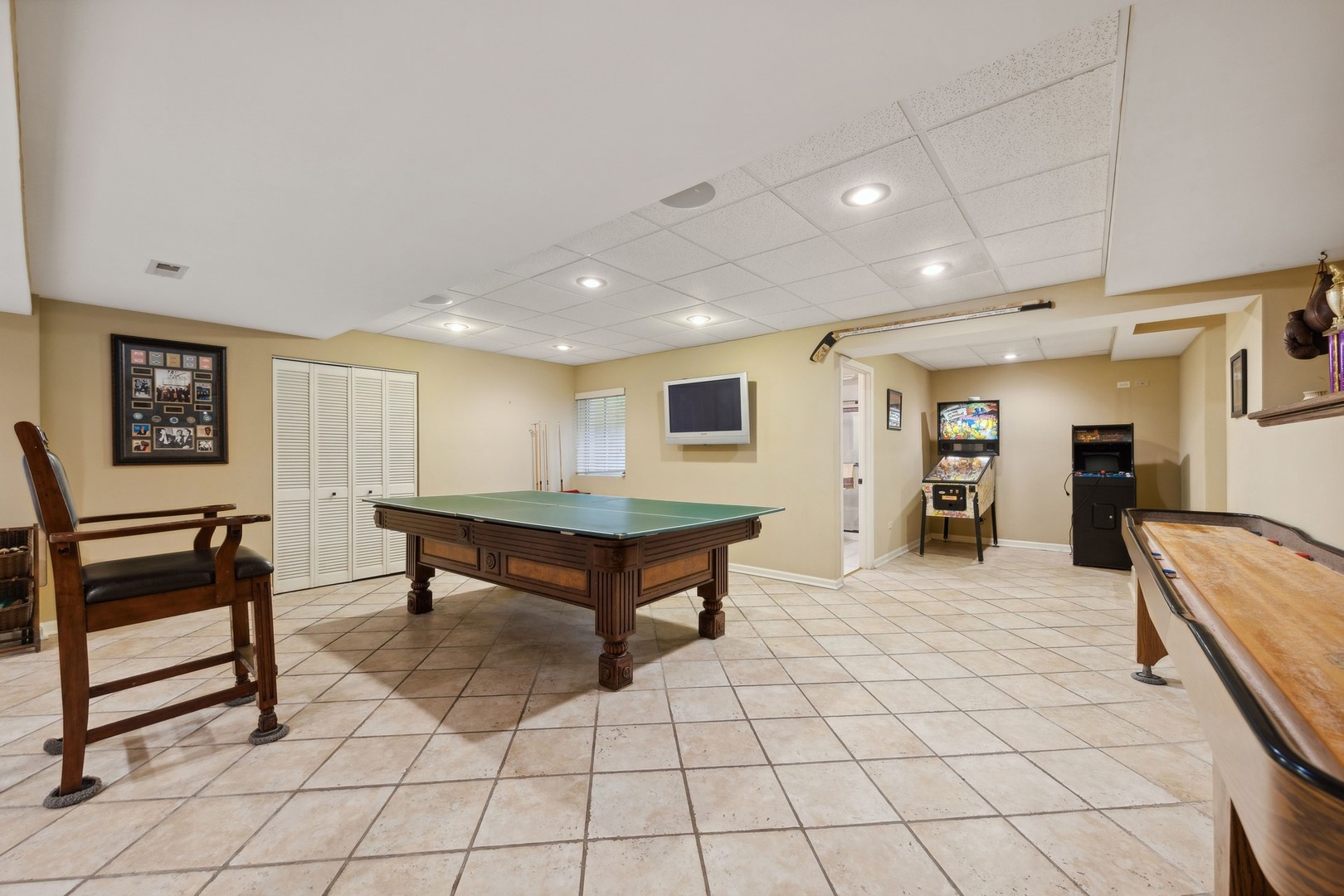719 South County Line Road Hinsdale, IL 60521 - Photo 38 of 52 a living room with furniture a table and kitchen appliances