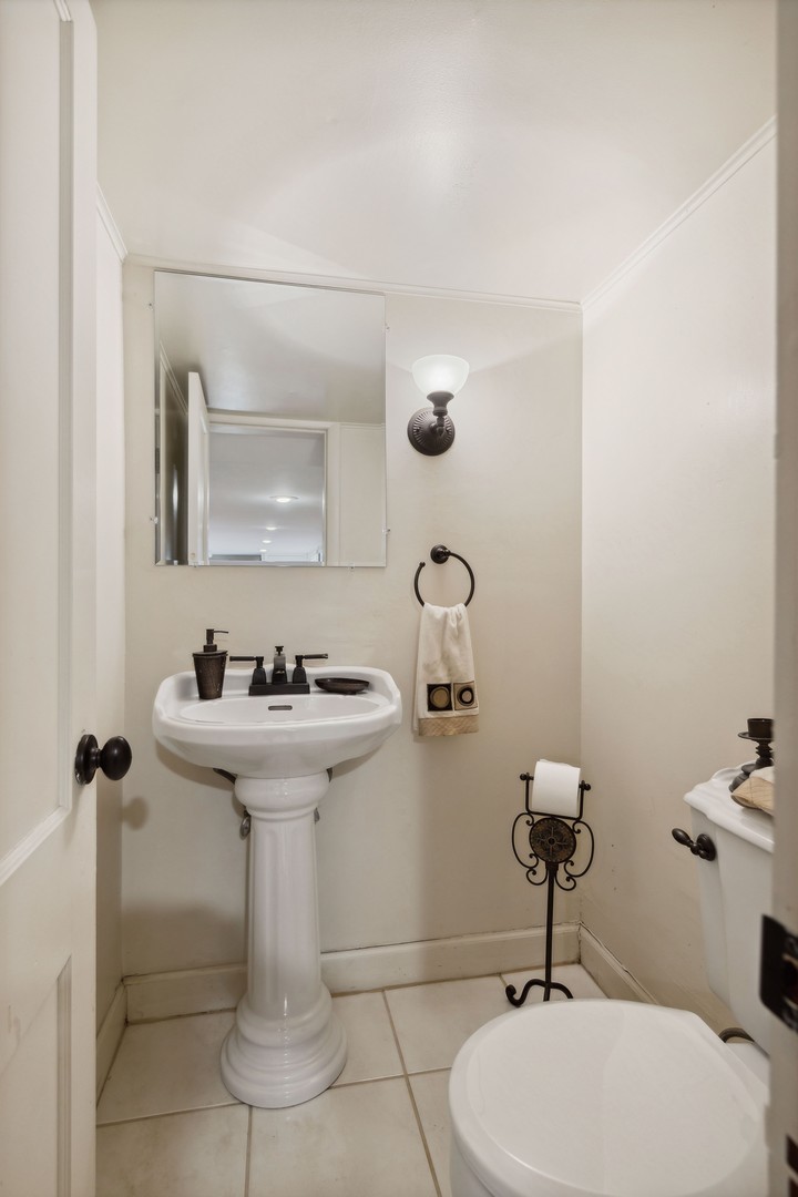 719 South County Line Road Hinsdale, IL 60521 - Photo 41 of 52 a bathroom with a sink toilet and mirror