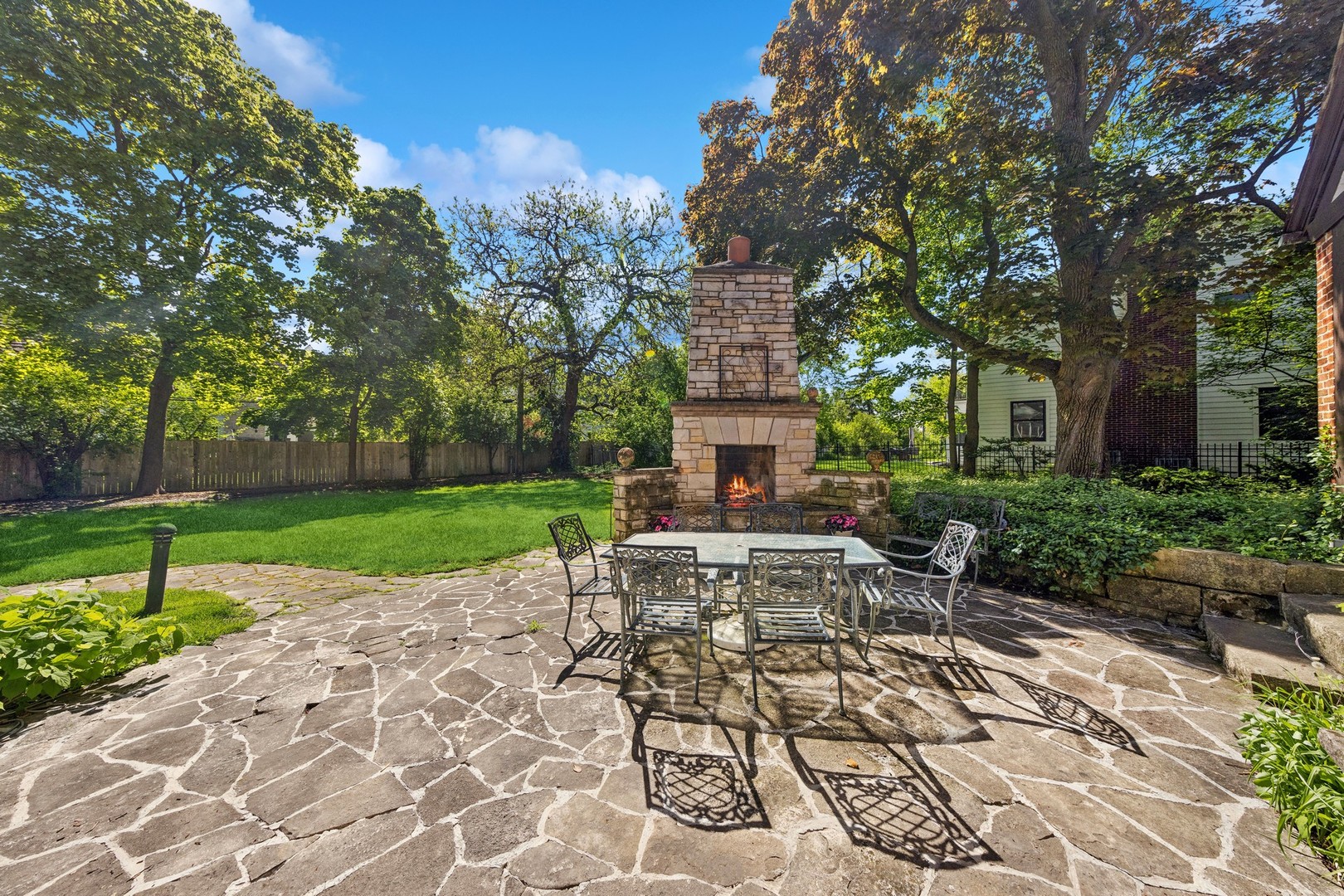 719 South County Line Road Hinsdale, IL 60521 - Photo 43 of 52 a view of a house with backyard sitting area and garden