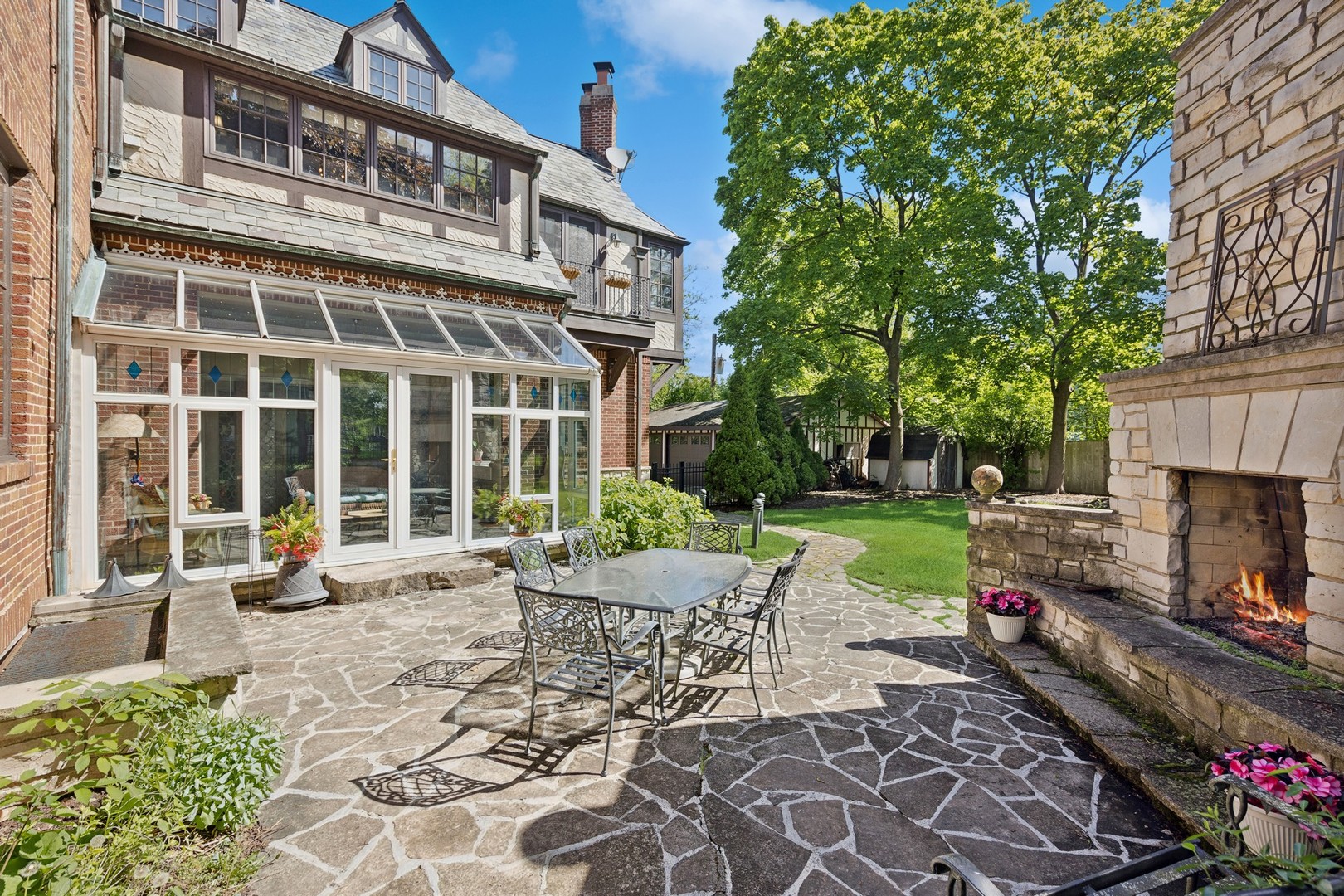 719 South County Line Road Hinsdale, IL 60521 - Photo 44 of 52 a view of a house with backyard sitting area and garden