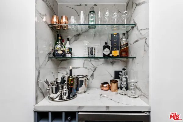 a kitchen with a refrigerator and stove top oven