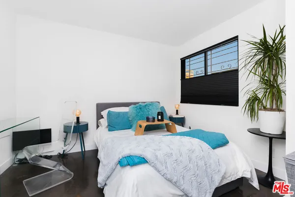 a bedroom with a bed and flat screen tv