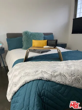 a bedroom with a bed and flat screen tv