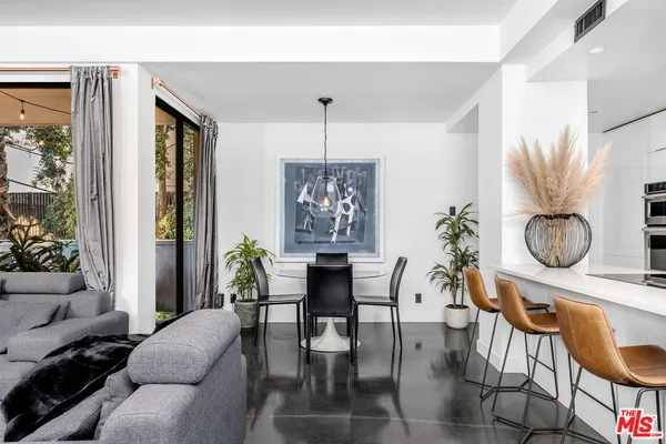 a living room with furniture a window and a table