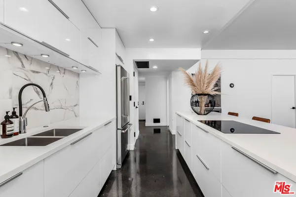 a kitchen with a sink and a refrigerator