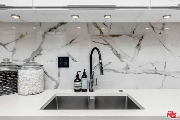 a view of a sink a faucet and a rug