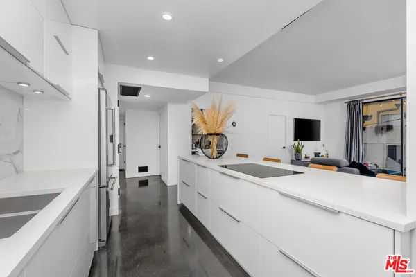 a room with a sink and a large mirror