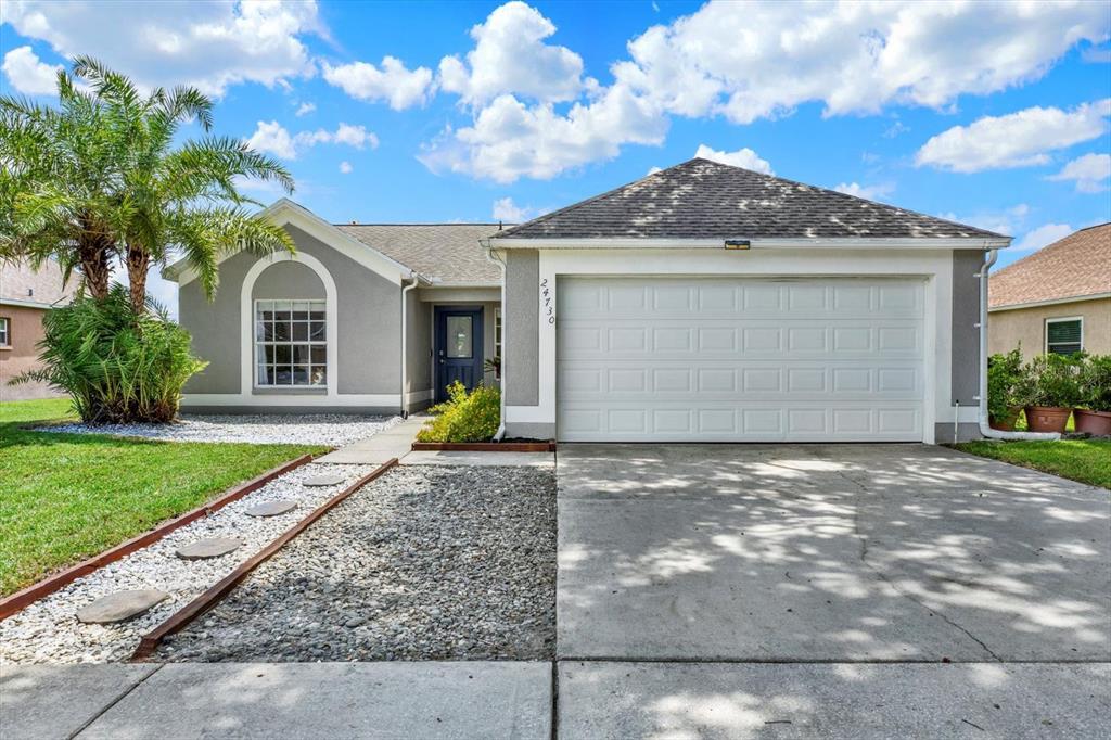 a view of a house with a yard and garage