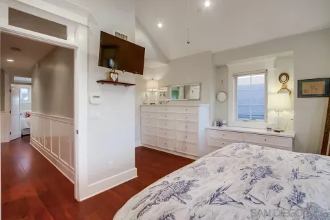 a bedroom with two bed and a dresser