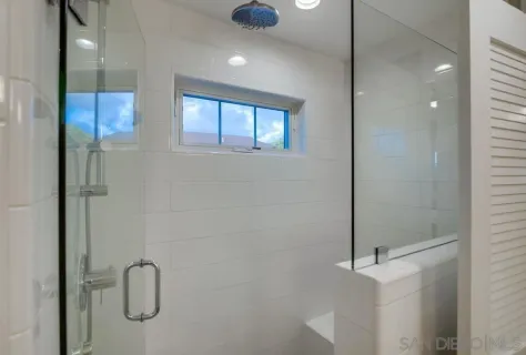 a living room with couches and a large mirror with wooden floor