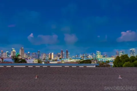 a view of a patio with table and chairs with wooden floor and fence
