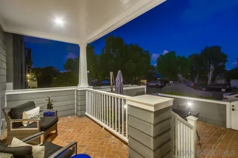 a view of a patio with table and chairs under an umbrella with wooden floor