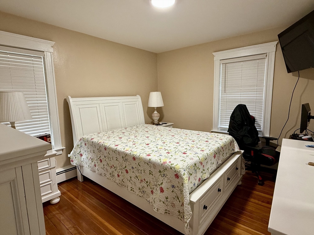 142 Cote Avenue Woonsocket, RI 02895 - Photo 11 of 22 a bedroom with a bed and a flat tv screen on the dresser
