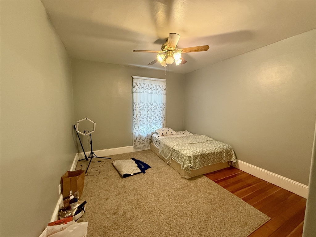 142 Cote Avenue Woonsocket, RI 02895 - Photo 14 of 22 a bedroom with a bed and a chandelier